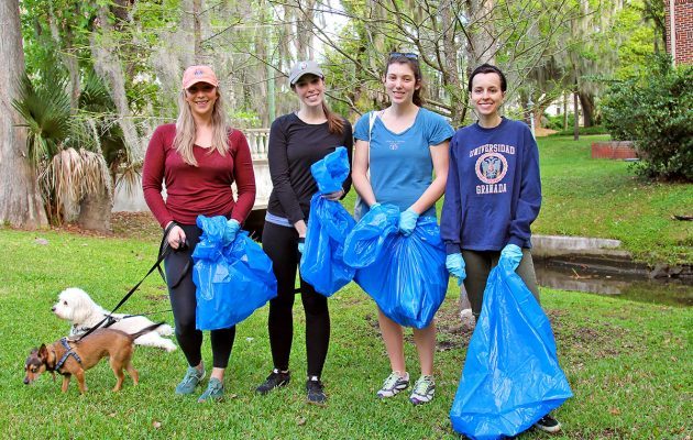 volunteers with garbage bags at park